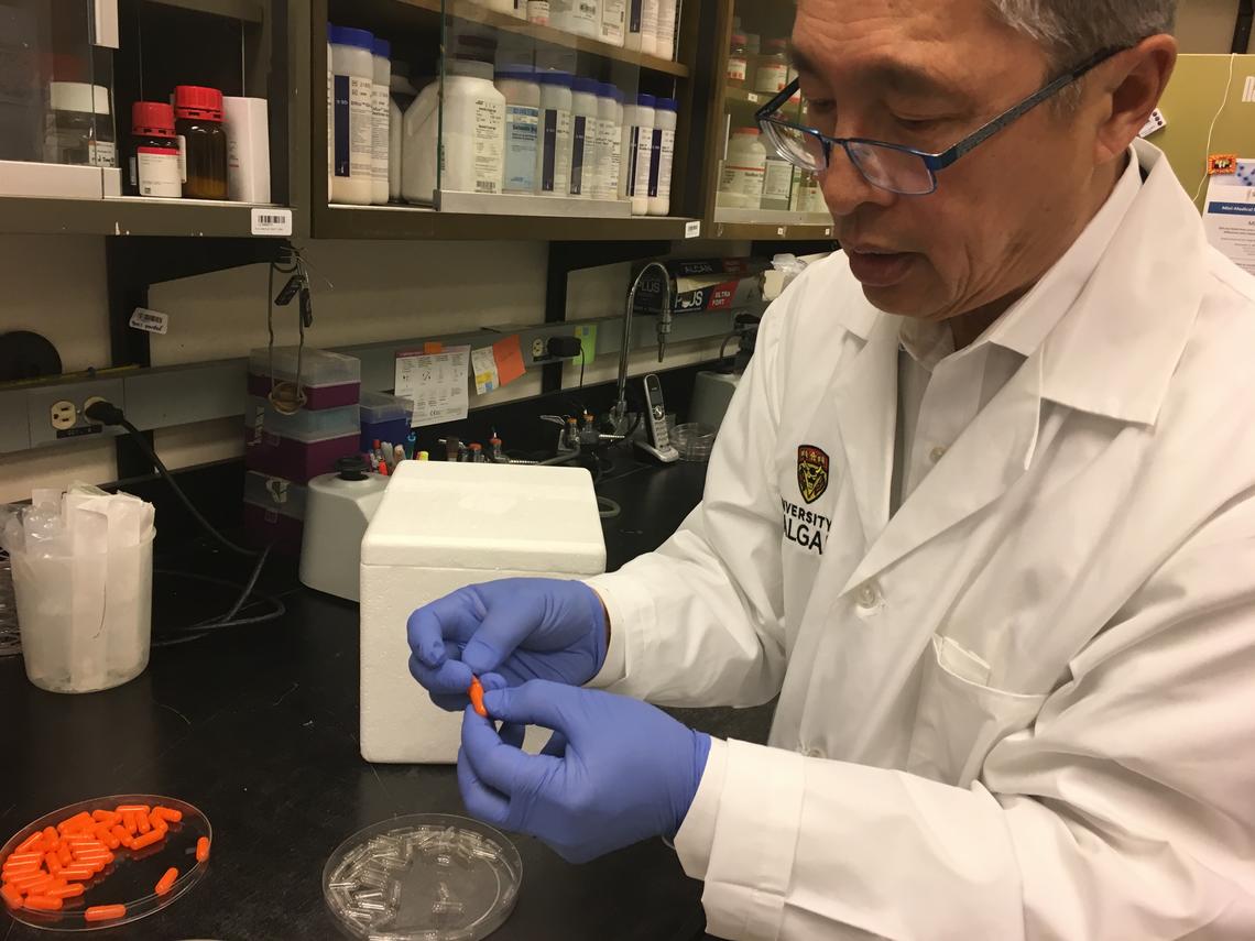 Thomas Louie with fecal capsule pills, which offer a less invasive way to treat C. difficile infections. 
