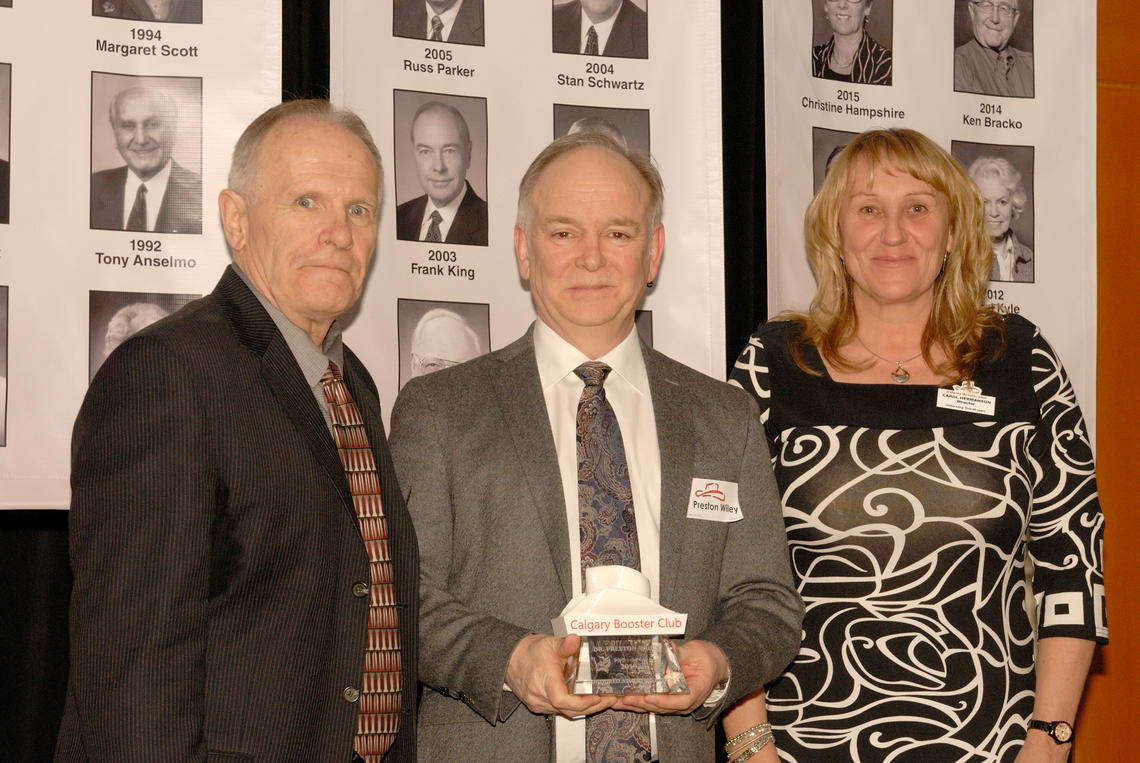 Preston Wiley, centre, receives the 2019 Honoured Athletic Leader award from Jon Jewell, Calgary Booster Club president, and Carol Hermansson, Booster Club director.