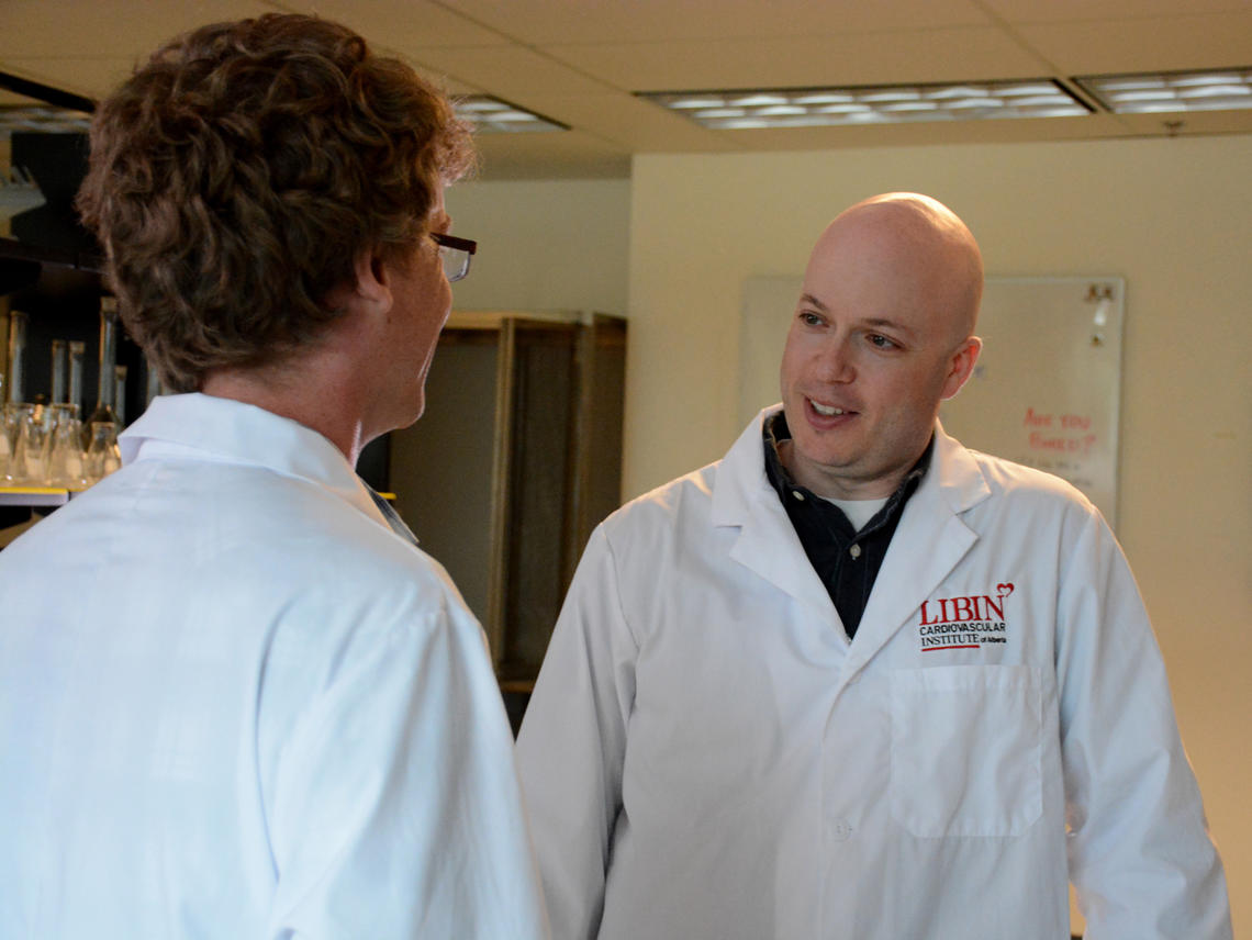 Dr. Robert Rose, PhD, speaks to a graduate student in his lab