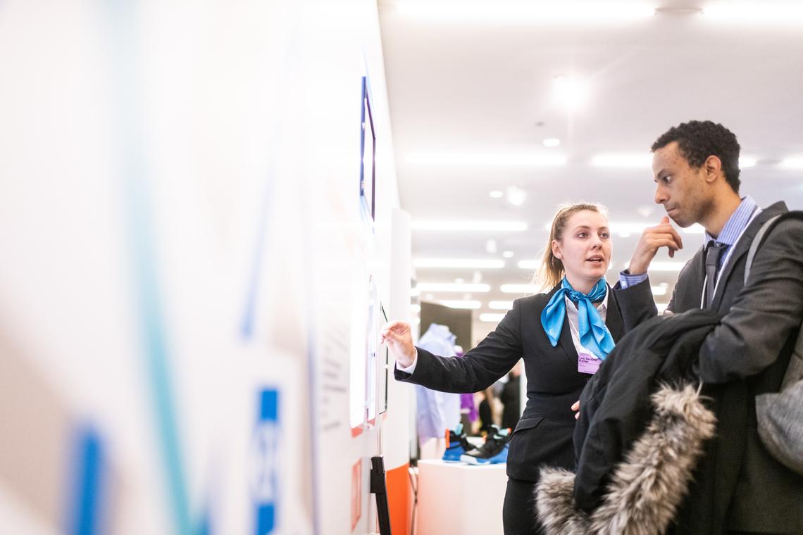 An employer speaking to a career fair attendee