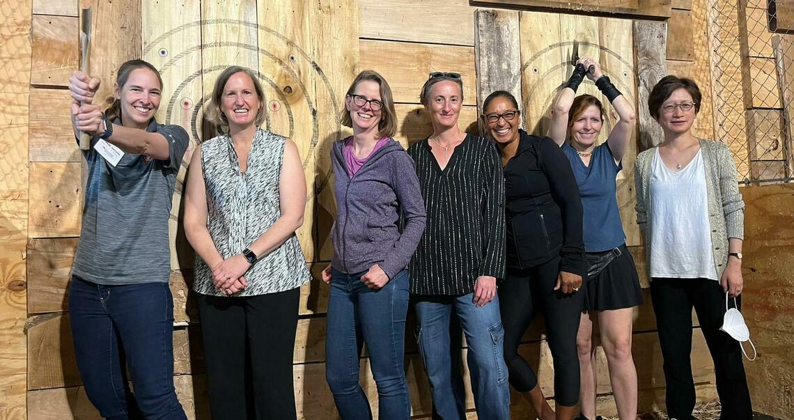 A group of people at an axe throwing event