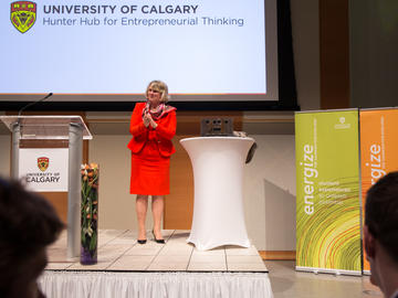 Elizabeth Cannon, University of Calgary president and vice-chancellor, presents the letter H from the old university sign as a gift.