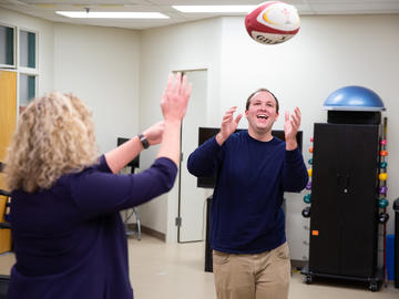 Physio patient throws ball