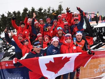 Tom Stephen (blue jacket and white headband first row, second from the right) celebrating medal win with the Canadian team at the World Juniors.  