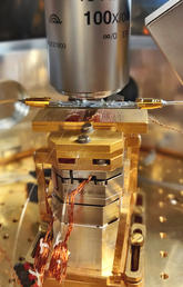 The innermost part of a quantum transduction experimental setup that has a diamond chip at its core.